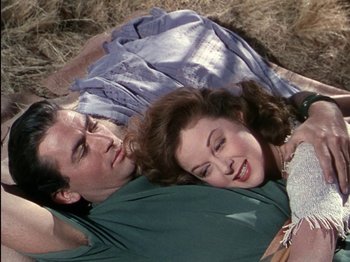 Movie still from “David and Bathsheba” (1951), directed by Henry King – A man and a woman laying on the ground; Medium shot, Overhead angle