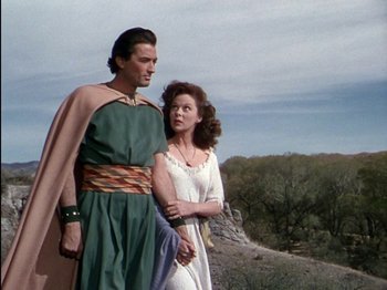 Movie still from “David and Bathsheba” (1951), directed by Henry King – A man and a woman standing next to each other on top of a hill; Medium shot, Low angle