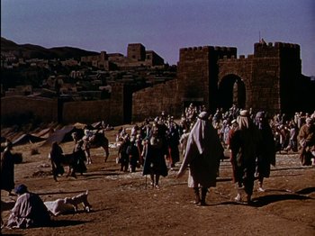Movie still from “David and Bathsheba” (1951), directed by Henry King – A group of people walking on a dirt field; Extreme Wide shot, High angle