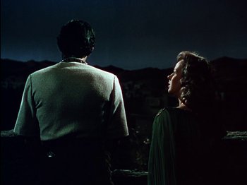 Movie still from “David and Bathsheba” (1951), directed by Henry King – A man and a woman standing next to each other in the dark; Medium shot, Low angle