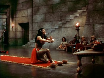 Movie still from “David and Bathsheba” (1951), directed by Henry King – A man in a costume is holding a sword in the middle of a scene; Wide shot, High angle
