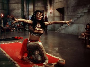 Movie still from “David and Bathsheba” (1951), directed by Henry King – A belly dancer is performing on a red carpet; Wide shot, High angle