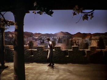 Movie still from “David and Bathsheba” (1951), directed by Henry King – A man standing in front of a wall with a painting on it; Extreme Wide shot, High angle