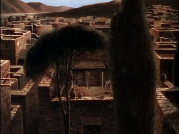 Movie still from “David and Bathsheba” (1951), directed by Henry King – An image of an old town with a tree in the foreground; Extreme Wide shot, High angle