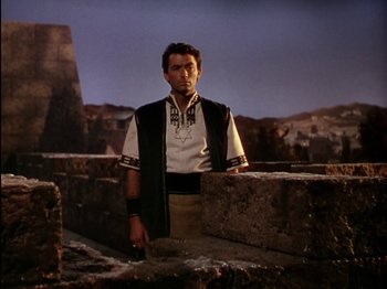 Movie still from “David and Bathsheba” (1951), directed by Henry King – A man standing on top of a stone wall; Medium shot, Low angle