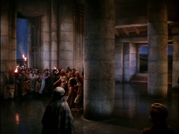 Movie still from “David and Bathsheba” (1951), directed by Henry King – A group of people standing around a building; Extreme Wide shot, High angle