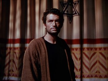 Movie still from “David and Bathsheba” (1951), directed by Henry King – A man wearing a brown robe standing in front of a curtain; Medium shot, Low angle
