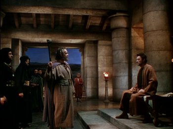 Movie still from “David and Bathsheba” (1951), directed by Henry King – A man in a robe stands in front of a man in a robe; Wide shot, High angle