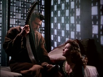 Movie still from “David and Bathsheba” (1951), directed by Henry King – A man and a woman are playing an instrument together; Medium shot, Low angle