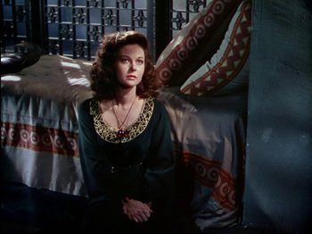 Movie still from “David and Bathsheba” (1951), directed by Henry King – A woman sitting on the ground in a room; Medium shot, High angle