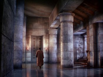 Movie still from “David and Bathsheba” (1951), directed by Henry King – A man in a brown coat walking through a room; Extreme Wide shot, High angle