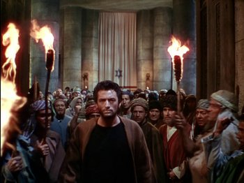 Movie still from “David and Bathsheba” (1951), directed by Henry King – A group of people are holding torches in front of a crowd; Wide shot, High angle