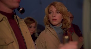 Movie still from “Dawn of the Dead” (1978), directed by George A. Romero – A woman in a tan jacket is looking at the camera; Close Up shot, Low angle