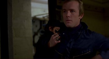 Movie still from “Dawn of the Dead” (1978), directed by George A. Romero – A man holding a cigarette in his mouth; Close Up shot, Over the shoulder angle