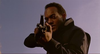 Movie still from “Dawn of the Dead” (1978), directed by George A. Romero – A man holding a gun in his hands; Close Up shot, Low angle