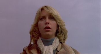 Movie still from “Dawn of the Dead” (1978), directed by George A. Romero – A woman with blonde hair wearing a sweater and a scarf; Close Up shot, Low angle