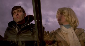 Movie still from “Dawn of the Dead” (1978), directed by George A. Romero – A man and a woman looking out of a window; Close Up shot, Low angle