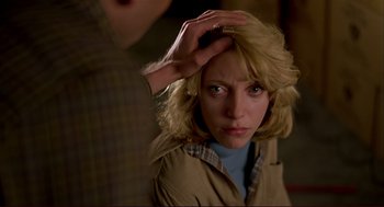 Movie still from “Dawn of the Dead” (1978), directed by George A. Romero – A woman with her hand on her head and a man touching her hair; Close Up shot, Over the shoulder angle