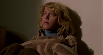 Movie still from “Dawn of the Dead” (1978), directed by George A. Romero – A woman sitting in a room with a blanket; Close Up shot, Low angle