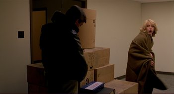 Movie still from “Dawn of the Dead” (1978), directed by George A. Romero – A man standing in front of a pile of boxes; Medium shot, Over the shoulder angle