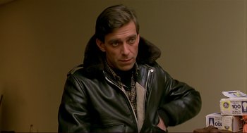 Movie still from “Dawn of the Dead” (1978), directed by George A. Romero – A man wearing a leather jacket with a fur collar; Close Up shot, Over the shoulder angle