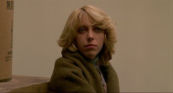 Movie still from “Dawn of the Dead” (1978), directed by George A. Romero – A woman wrapped in a blanket looking at the camera; Close Up shot, Low angle