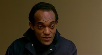 Movie still from “Dawn of the Dead” (1978), directed by George A. Romero – A person wearing a black jacket; Close Up shot, High angle