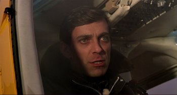 Movie still from “Dawn of the Dead” (1978), directed by George A. Romero – A person in a black jacket; Close Up shot, High angle