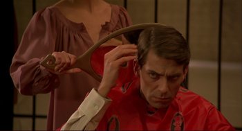 Movie still from “Dawn of the Dead” (1978), directed by George A. Romero – A man is getting his hair combed by a woman; Close Up shot, Over the shoulder angle