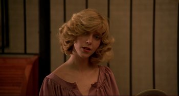 Movie still from “Dawn of the Dead” (1978), directed by George A. Romero – A woman with blonde curly hair wearing a pink top; Close Up shot, Low angle