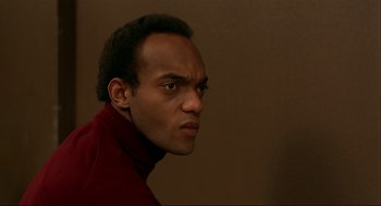 Movie still from “Dawn of the Dead” (1978), directed by George A. Romero – A person wearing a red shirt; Close Up shot, Low angle