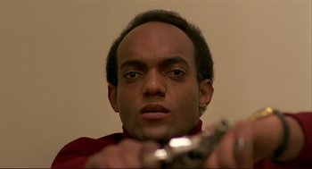 Movie still from “Dawn of the Dead” (1978), directed by George A. Romero – A person holding a gun; Close Up shot, Low angle