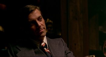 Movie still from “Dawn of the Dead” (1978), directed by George A. Romero – A person wearing a suit and tie; Close Up shot, Over the shoulder angle