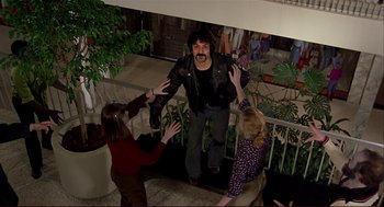 Movie still from “Dawn of the Dead” (1978), directed by George A. Romero – A group of people standing next to each other in a building; Wide shot, High angle