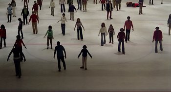 Movie still from “Dawn of the Dead” (1978), directed by George A. Romero – A group of people standing on top of an ice skating rink; Extreme Wide shot, High angle