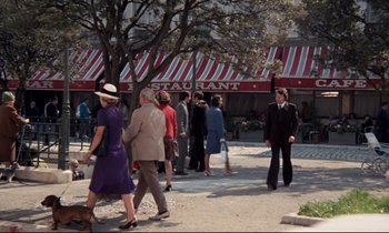 Movie still from “Day for Night” (1973), directed by François Truffaut – A group of people walking down a street; Wide shot, High angle