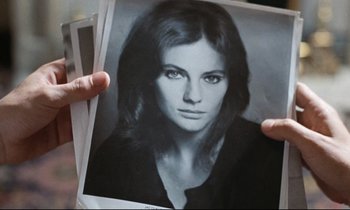 Movie still from “Day for Night” (1973), directed by François Truffaut – A person holding a picture of a woman; Extreme Close Up shot, High angle