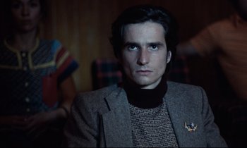 Movie still from “Day for Night” (1973), directed by François Truffaut – A man in a jacket and sweater looking at the camera; Close Up shot, Low angle