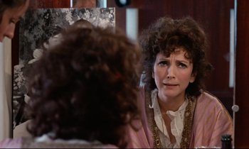 Movie still from “Day for Night” (1973), directed by François Truffaut – A woman sitting in front of a mirror looking at herself in the mirror; Close Up shot, Over the shoulder angle