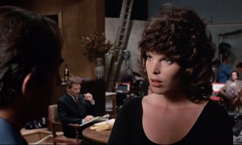 Movie still from “Day for Night” (1973), directed by François Truffaut – A woman in a black shirt and a man in a black suit; Close Up shot, Over the shoulder angle