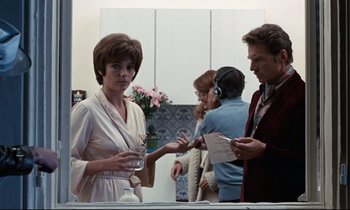 Movie still from “Day for Night” (1973), directed by François Truffaut – A group of people standing in front of a bathroom mirror; Medium shot, Over the shoulder angle