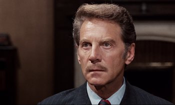 Movie still from “Day for Night” (1973), directed by François Truffaut – An older man in a suit and tie looking to his left; Close Up shot, Low angle