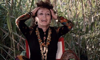 Movie still from “Day for Night” (1973), directed by François Truffaut – A woman sitting in a chair with her hands on her head; Close Up shot, Over the shoulder angle