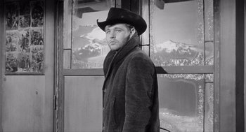 Movie still from “Day of the Outlaw” (1959), directed by André De Toth – A black and white photo of a man wearing a cowboy hat; Medium shot, Low angle