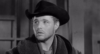 Movie still from “Day of the Outlaw” (1959), directed by André De Toth – A black and white photo of a man wearing a cowboy hat; Close Up shot, Low angle