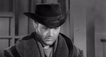 Movie still from “Day of the Outlaw” (1959), directed by André De Toth – A black and white photo of a man wearing a cowboy hat; Close Up shot, Low angle