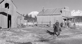 Movie still from “Day of the Outlaw” (1959), directed by André De Toth – An old photo of a man on a horse; Wide shot, Low angle