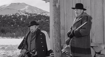 Movie still from “Day of the Outlaw” (1959), directed by André De Toth – A couple of men standing next to each other on top of a hill; Medium shot, Low angle