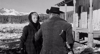 Movie still from “Day of the Outlaw” (1959), directed by André De Toth – An old photo of a man and a young woman; Medium shot, Over the shoulder angle
