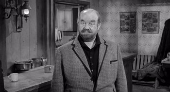 Movie still from “Day of the Outlaw” (1959), directed by André De Toth – An older man wearing a jacket and a tie; Medium shot, Over the shoulder angle